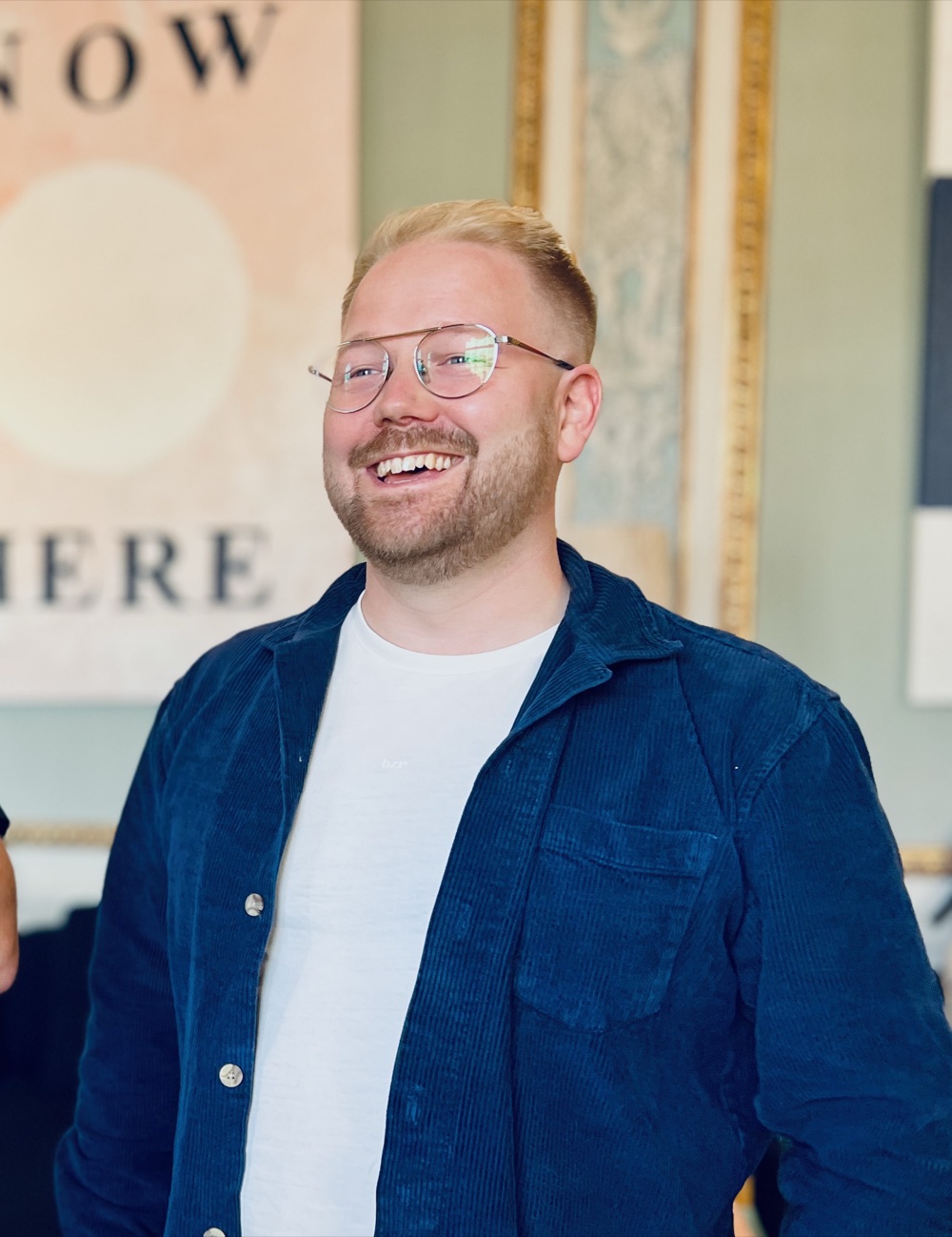 Jonas Wärngård portrait 1 — smiling, glasses and a blue corduroy shirt